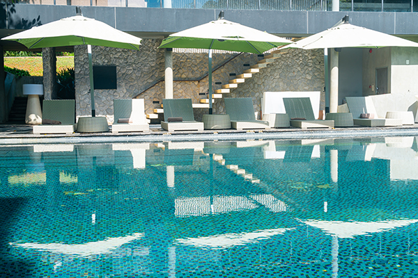 bed pool with umbrella around swimming pool